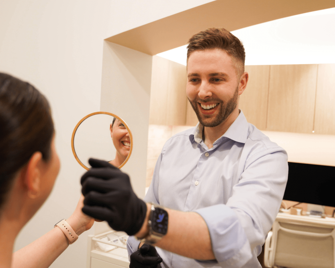 Dr. Scott Allison with a client discussing treatment options – What Qualifications Should You Look for in a Dermatologist