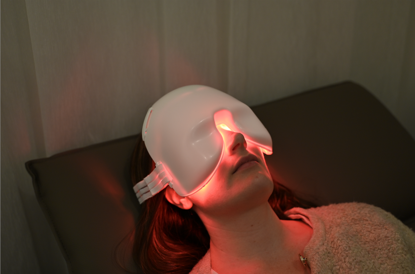 Close view of red glowing mask used for low level light therapy for eyes on a relaxed patient.